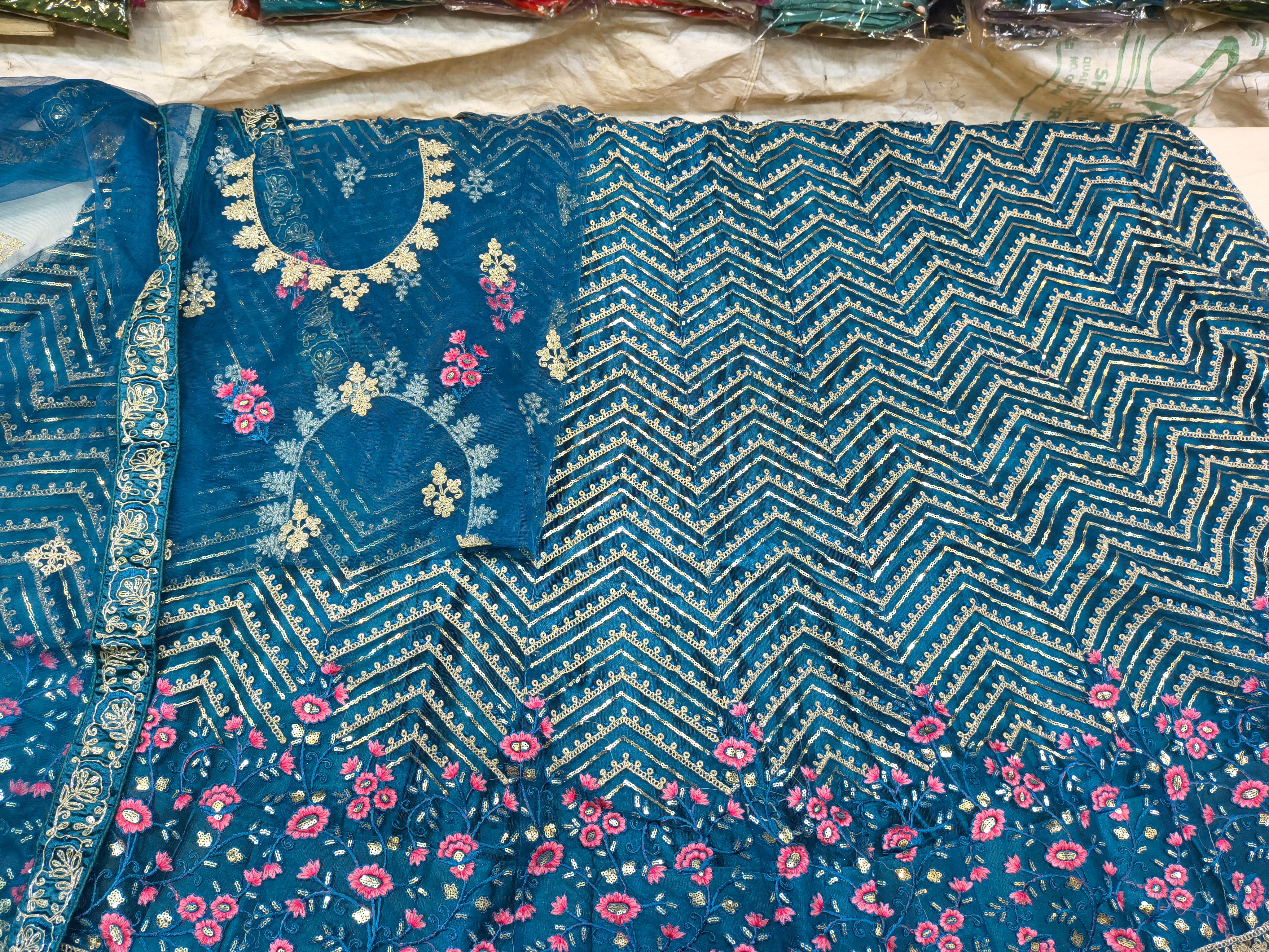 Teal Blue Unstitched Embroidered Net Lehenga Choli with Floral Border & Dupatta
